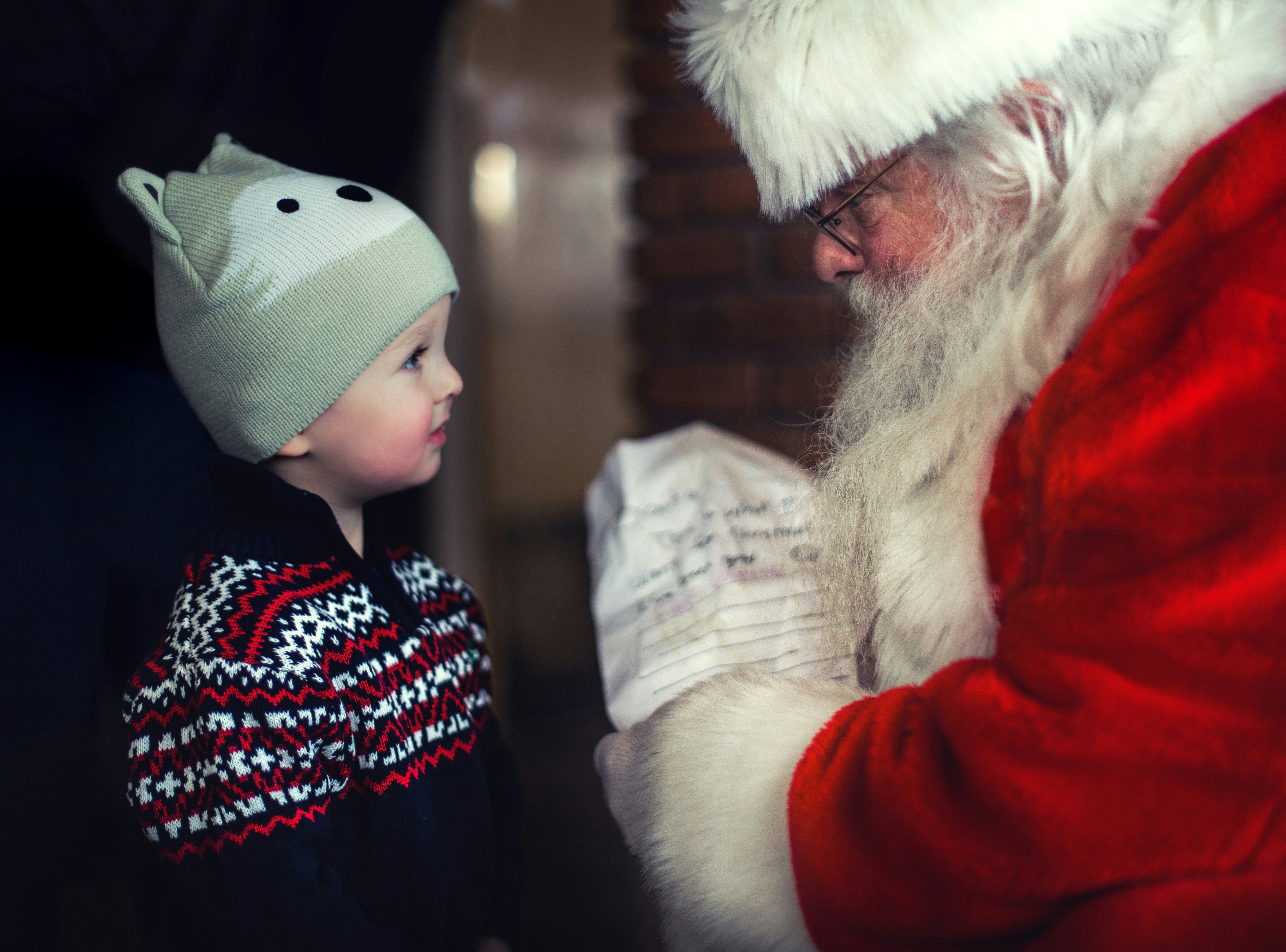 Santa Claus talking to a young child